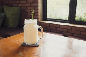 coconut water frappe with rosemary leaf on restaurant table photo