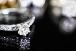 Jewelry diamond rings with reflection on black background photo