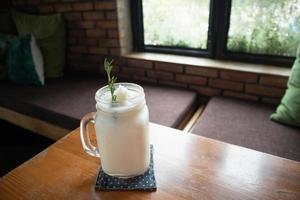 coconut water frappe with rosemary leaf on restaurant table photo