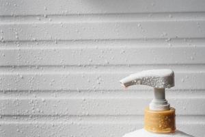 Water drop on liquid soap dispenser pump during bath time photo