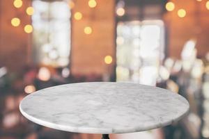 round marble table top with cafe restaurant bokeh lights abstract background for montage product display photo