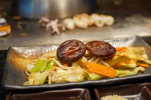 Stir fried Shiitake mushroom with vegetable dish in teppanyaki restaurant photo