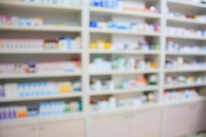 blur shelves of drugs in the pharmacy shop photo