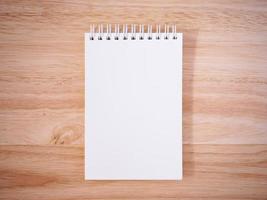 Notepad on the wooden desk table photo