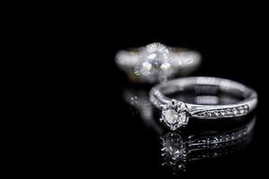 Close up Jewelry diamond ring on black background with reflection photo