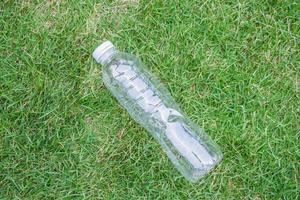 plastic bottle on green grass background recycle and pollution concept photo