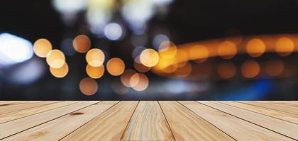 Empty wood table top with abstract blur bokeh light defocused background photo