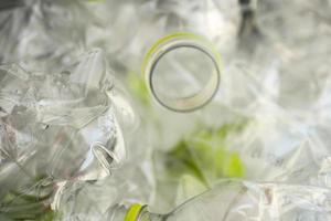 Crushed plastic bottles for recycling abstract background photo