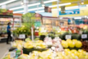 Supermarket grocery store with fruit and vegetable on shelves blurred background photo