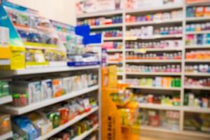 Pharmacy drug store interior blurred background with medicine on shelves photo