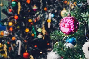 Decorated Christmas tree with colorful bauble on sparkling bokeh light blurred background photo