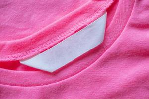 blank laundry care clothes label on pink shirt photo