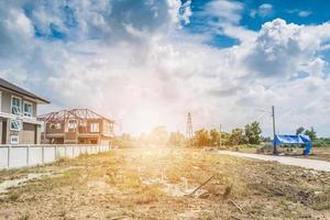 Residential new house building at construction site with clouds and blue sky photo