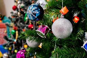 Decorated Christmas tree with colorful bauble on sparkling bokeh light blurred background photo