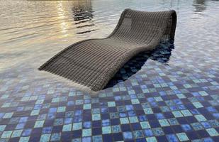 relax deck chair by the blue pool at swimming pool in luxury spa resort or villa Tourism industry photo