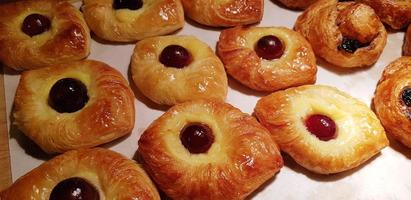 Surtido de hojaldre dulce recién horneado relleno de fruta y mermelada y hojaldre relleno de chocolate danés foto