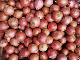 Shallots. Fresh purple shallots on bamboo basket. Shallots close up. photo