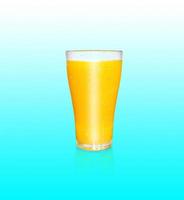 A glass of orange juice contains orange pulp. with the reflection of a glass of orange juice on a blue background photo