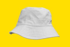 white bucket hat isolated on yellow photo