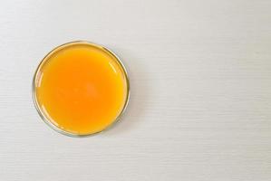 orange juice in a glass with vitamin C useful top view on white table photo