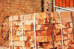 A pack of fireclay bricks in a construction warehouse on the street. The concept of repair and building materials photo