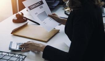 Male lawyer working with contract papers and wooden gavel on tabel in courtroom. justice and law ,attorney, court judge, concept. photo