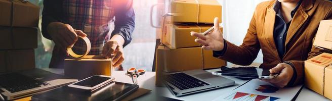 Business woman start up small business entrepreneur SME success .freelance woman working at home with Online Parcel delivery. SME and packaging deliveryconcept photo