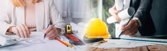 Two colleagues discussing data working and tablet, laptop with on on architectural project at construction site at desk in office photo