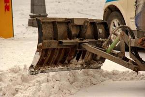 Snow removal from the streets with the help of special equipment in winter photo