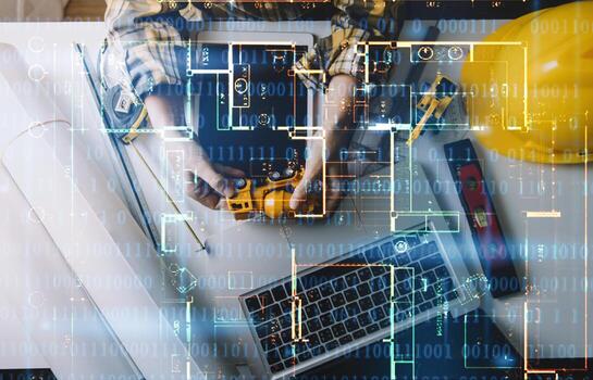 Two colleagues discussing data working and tablet, laptop with on on architectural project at construction site at desk in office photo