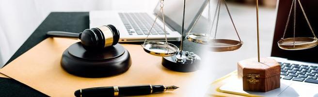 Business and lawyers discussing contract papers with brass scale on desk in office. Law, legal services, advice, justice and law concept picture with film grain effect photo