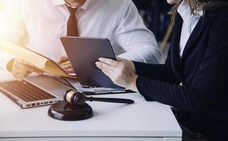 Male lawyer working with contract papers and wooden gavel on tabel in courtroom. justice and law ,attorney, court judge, concept. photo