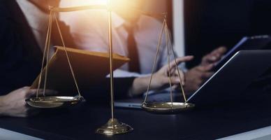 Male lawyer working with contract papers and wooden gavel on tabel in courtroom. justice and law ,attorney, court judge, concept. photo