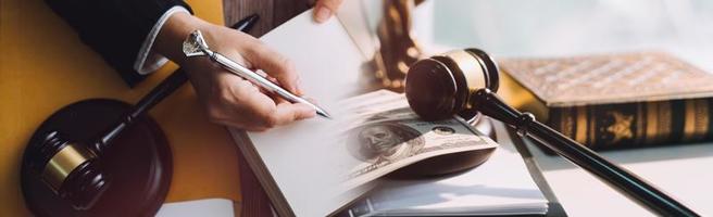 Business and lawyers discussing contract papers with brass scale on desk in office. Law, legal services, advice, justice and law concept picture with film grain effect photo