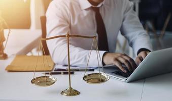 Male lawyer working with contract papers and wooden gavel on tabel in courtroom. justice and law ,attorney, court judge, concept. photo