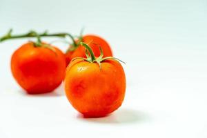 tometoes isolate on white background. bunch the red tometos isolated in white background its fresh nutritious and citrious photo