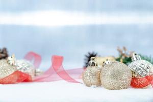 Christmas of  winter - Christmas balls with ribbon on snow, Winter holidays concept. Christmas red balls, golden balls, pine And Snowflakes decorations In Snow Background photo