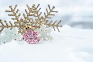 Christmas of  winter - Christmas Snowflakes on snow, Winter holidays concept. White and Golden Snowflakes decorations In Snow Background photo