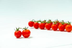 tometoes isolate on white background. bunch the red tometos isolated in white background its fresh nutritious and citrious photo