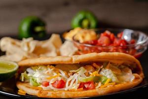 Tacos with Mango Salsa and Chips.Mixed mexican food Guacamole, nachos, fajita, meat tacos. Top view. Tex mex cuisine. photo