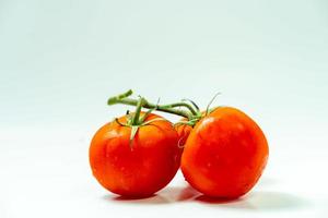 tometoes isolate on white background. bunch the red tometos isolated in white background its fresh nutritious and citrious photo