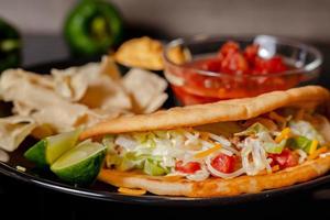 Tacos with Mango Salsa and Chips.Mixed mexican food Guacamole, nachos, fajita, meat tacos. Top view. Tex mex cuisine. photo