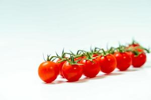 tometoes isolate on white background. bunch the red tometos isolated in white background its fresh nutritious and citrious photo