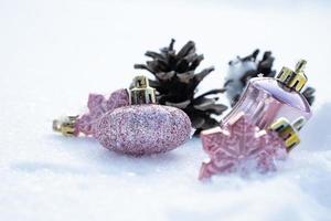 Christmas - Baubles Decorated, Pink xmas balls, Pine And Snowflakes In Snowing Background photo