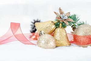 Christmas of  winter - Christmas balls with ribbon on snow, Winter holidays concept. Christmas red balls, golden balls, pine And Snowflakes decorations In Snow Background photo