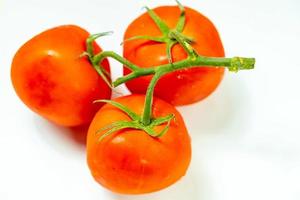 tometoes isolate on white background. bunch the red tometos isolated in white background its fresh nutritious and citrious photo