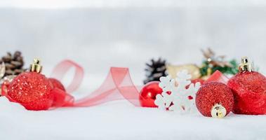 Christmas of  winter - Christmas balls with ribbon on snow, Winter holidays concept. Christmas red balls, golden balls, pine And Snowflakes decorations In Snow Background photo