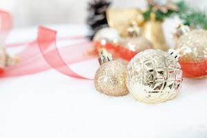 Christmas of  winter - Christmas balls with ribbon on snow, Winter holidays concept. Christmas red balls, golden balls, pine And Snowflakes decorations In Snow Background photo