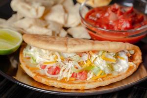 Tacos with Mango Salsa and Chips.Mixed mexican food Guacamole, nachos, fajita, meat tacos. Top view. Tex mex cuisine. photo