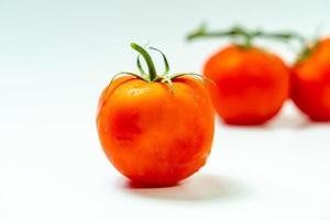 tometoes isolate on white background. bunch the red tometos isolated in white background its fresh nutritious and citrious photo